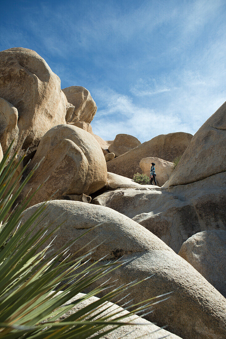 Woman sightseeing rock formations in Joshua Tree National Park, California, USA