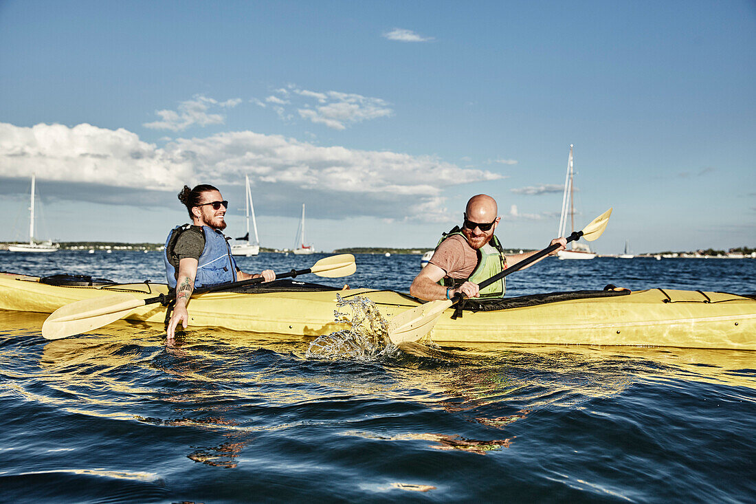 Photograph of two men in tandem sea kayak, Portland, Maine, USA