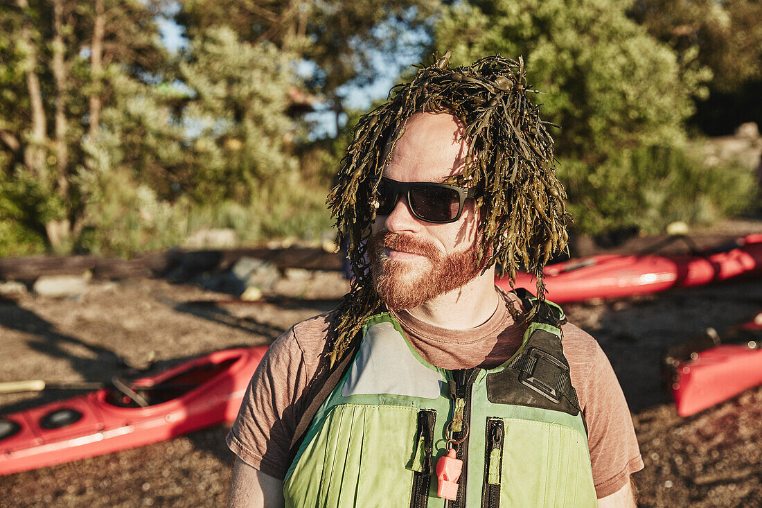 Humorous photograph of man with seaweed wig, Portland, Maine, USA