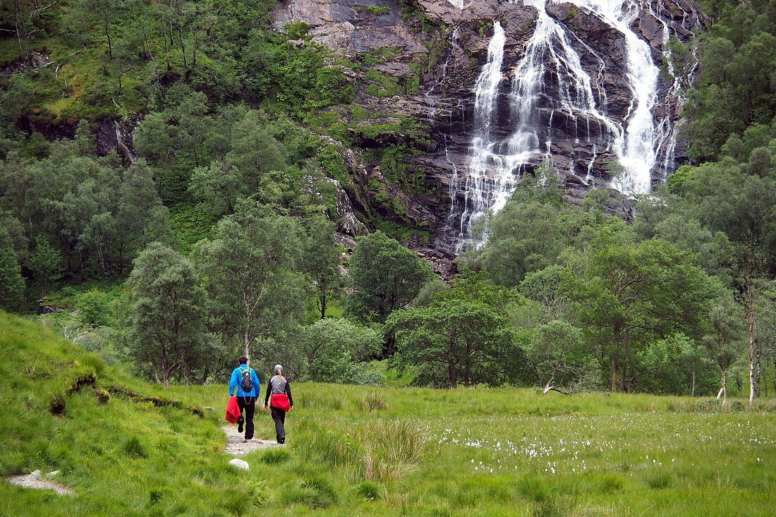 Wandern mit Wasserfall im Glen Nevis unter dem Ben Nevis bei Fort William, Schottland