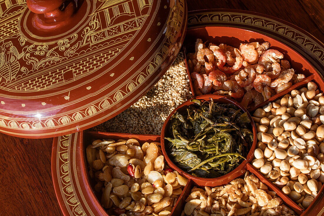 Snack bowl of tea leaf, ginger, dried shrimp, nuts and sesame seed aboard Ayeyarwady (Irrawaddy) river cruise ship Anawrahta (Heritage Line), near Nyanchaydock, Sagaing, Myanmar