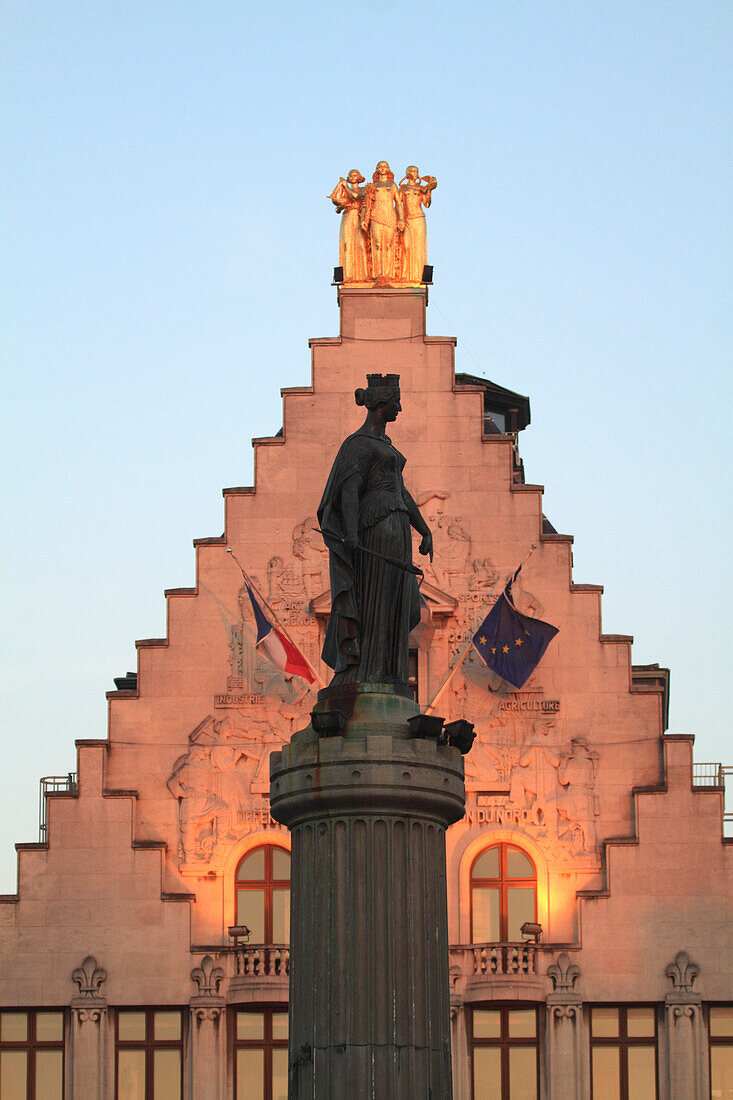 France, North-Eastern France, Lille, Column of the Goddess on General De Gaulle square. Background : headquarters of the newspaper La Voix du Nord with 3 golden statues at its top (representing 3 French regions)