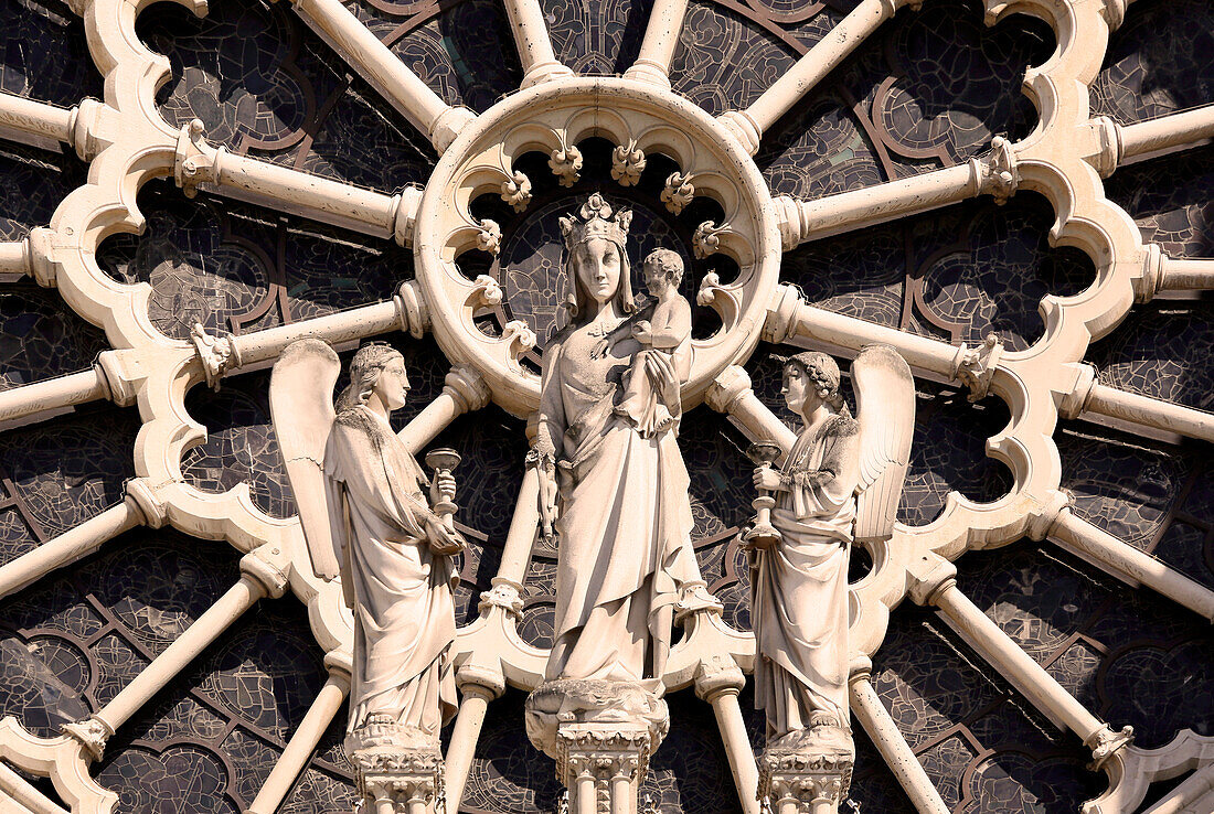 France, Paris, 4th arrondissement, Notre Dame Cathedral, closeup of the western rose and the sculpture of the Virgin