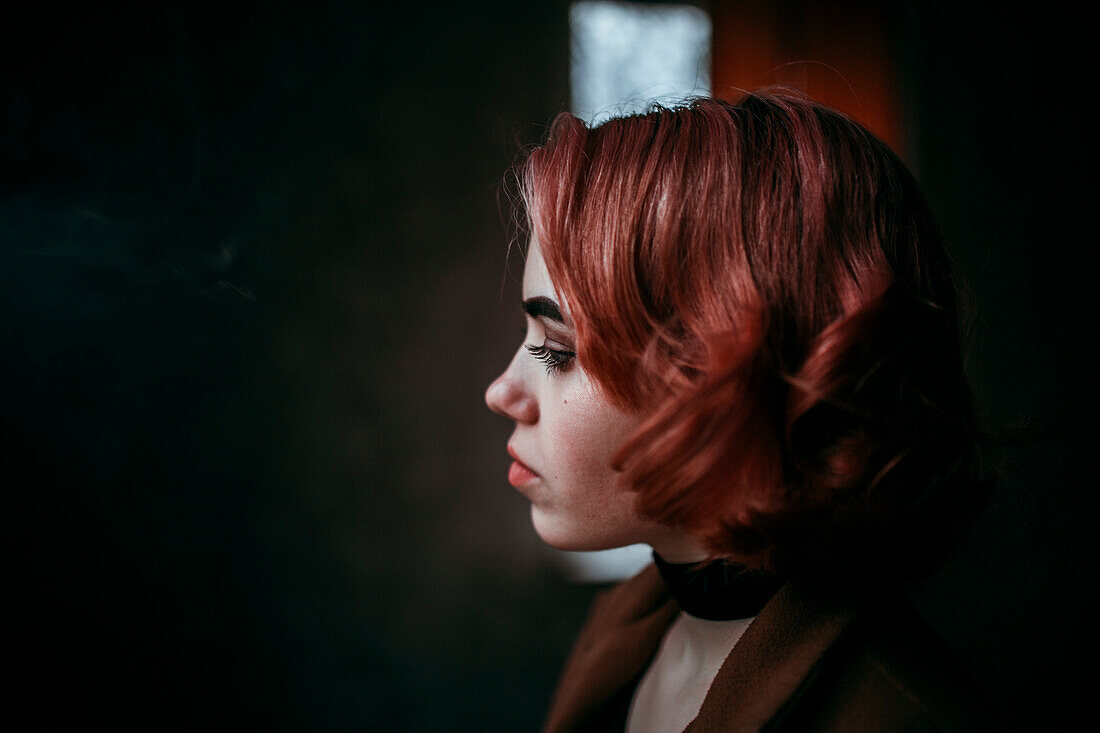 Pensive Caucasian woman with red hair