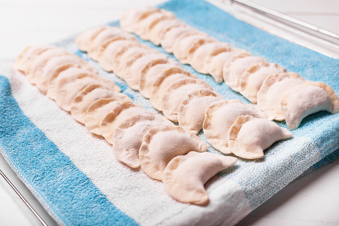 Rows of pierogies on towel