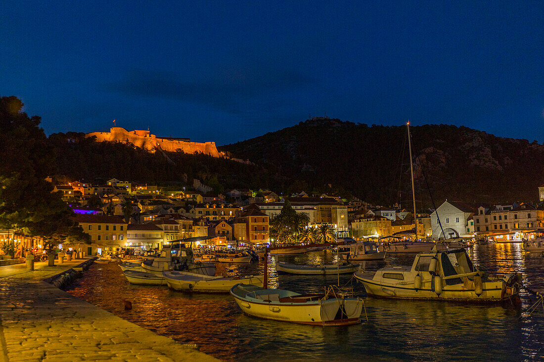 Scenic view of boats at waterfront at night