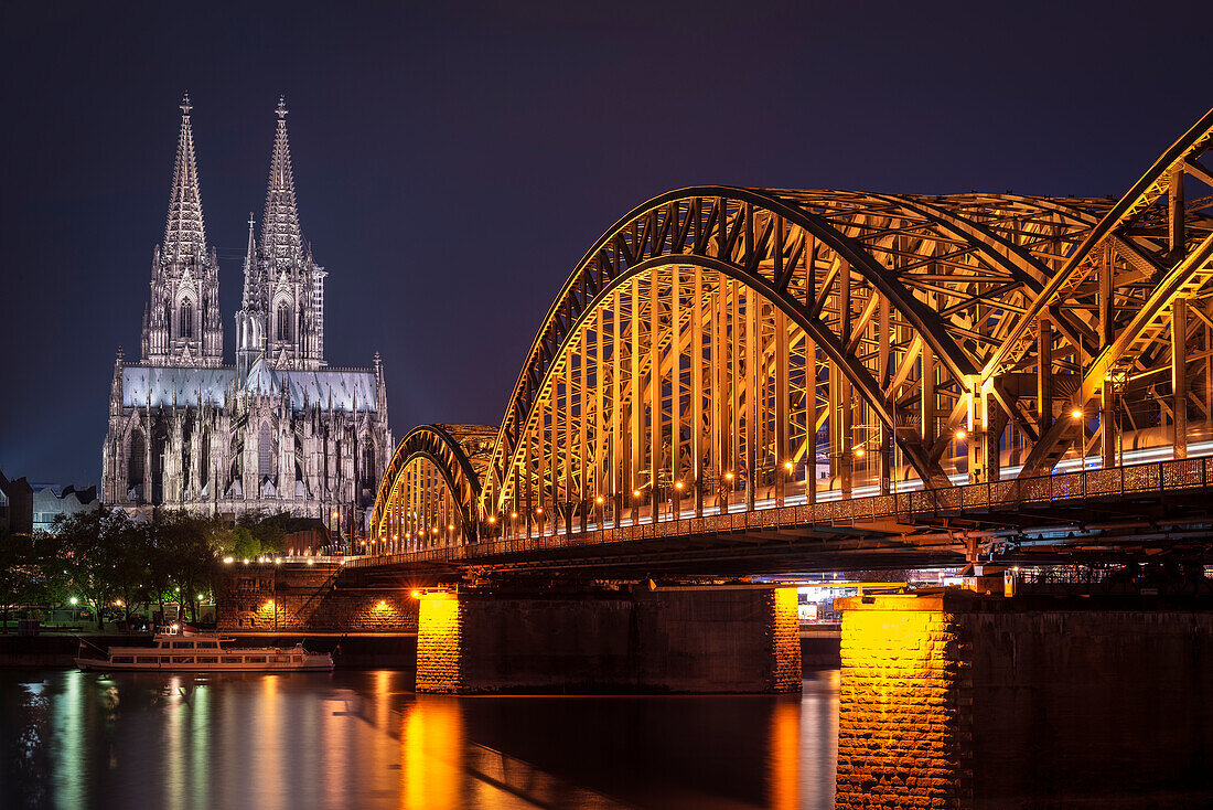 UNESCO World Heritage Cologne cathedral at dusk, Hohenzollern Bridge across Rhine River, Cologne, North Rhine-Westphalia, Germany