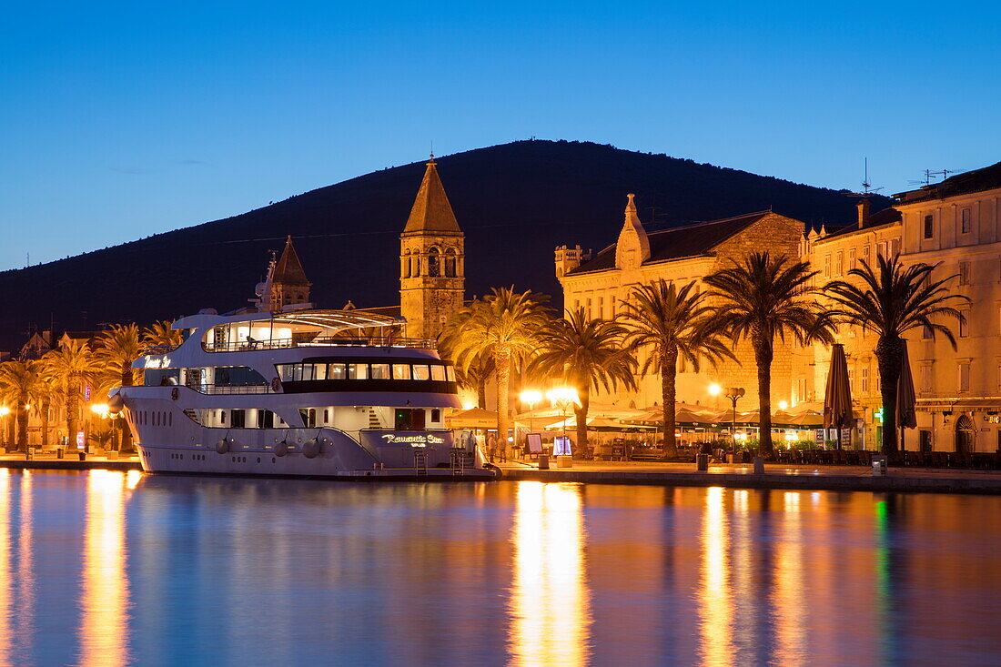 Cruise ship MS Romantic Star (Reisebüro Mittelthurgau) and illuminated Old Town at dusk, Trogir, Split-Dalmatia, Croatia
