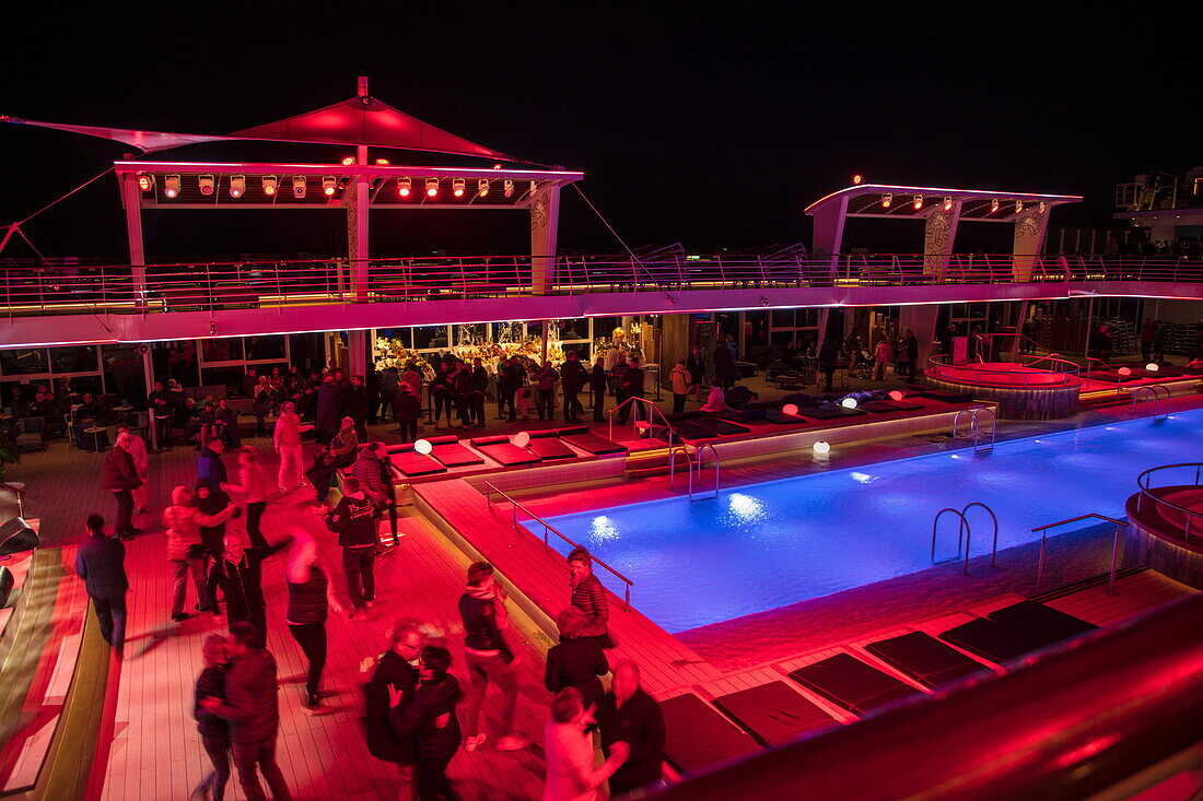 Pool party on Pooldeck of cruise ship Mein Schiff 6 (TUI Cruises) at night, Baltic Sea, near Denmark
