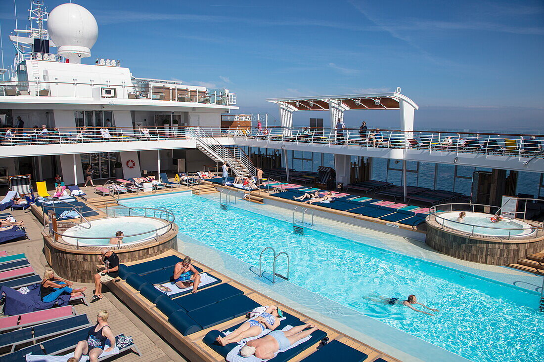 People enjoy a sunny afternoon on Pooldeck of cruise ship MS Mein Schiff 6 (TUI Cruises), Baltic Sea, near Rønne, Bornholm, Denmark