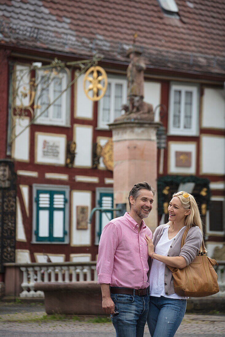 Couple enjoys stroll through Altstadt old town, Bad Orb, Spessart-Mainland, Hesse, Germany