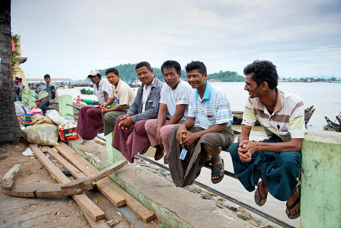 Men along the harbour foreshore in Myeik in Myanmar