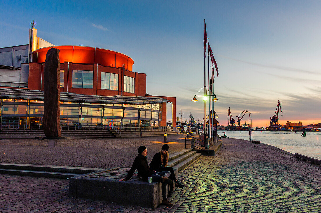People are sitting in front of opera at the harbor, Sweden