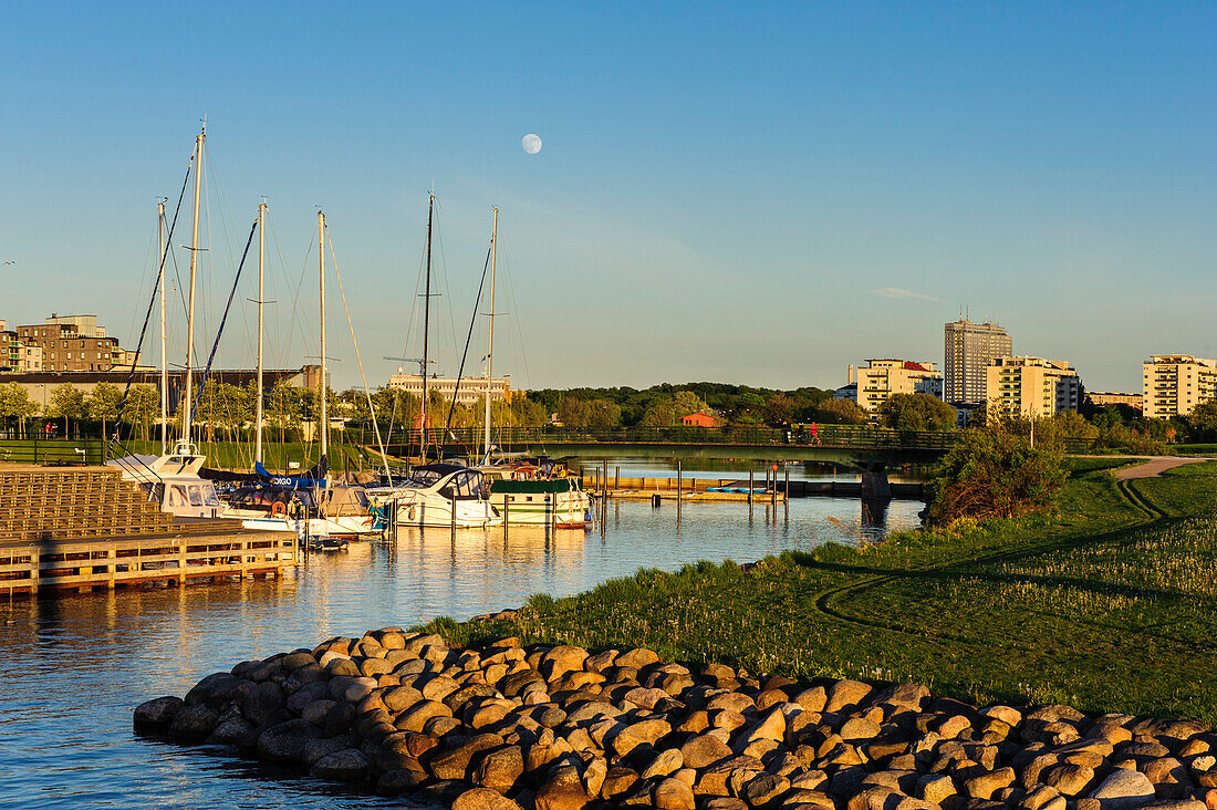 Yachthafen in the evening light with full moon, Restored harbor area, Malmo, Southern Sweden, Sweden