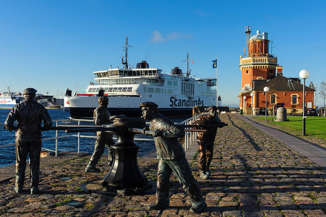 Harbor with ferry from Helsingborg to Helsingoer, monument in foreground, Helsingborg, Southern Sweden, Skane, Southern Sweden, Sweden