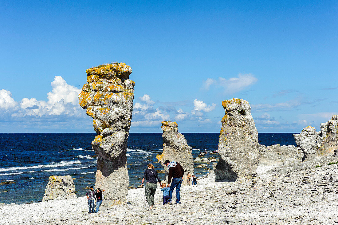 People at Rocky Coast Faroe called Raukar, Raukar are up to over 10 meters high limestone pillars found on Gotland / Faroe Island., Schweden