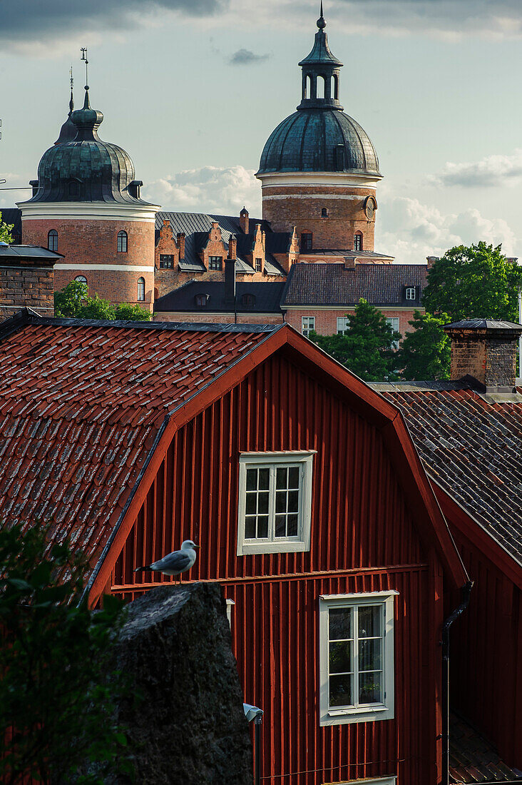 Wooden house in Mariefred, Gripsholm Castle in the background, Sweden