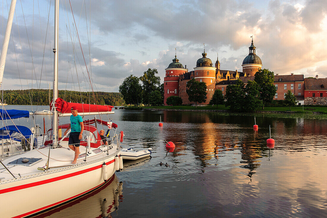 Gripsholm Castle and marina with blond boy in the foreground, Sweden