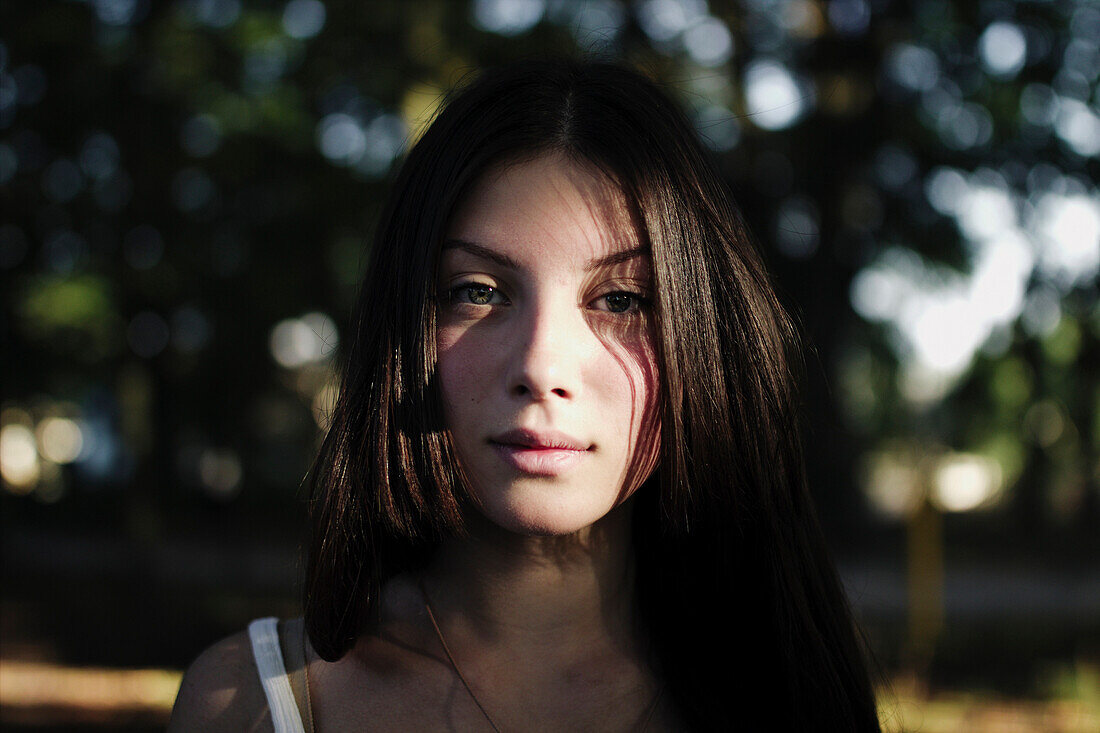 Portrait of serious Caucasian girl outdoors