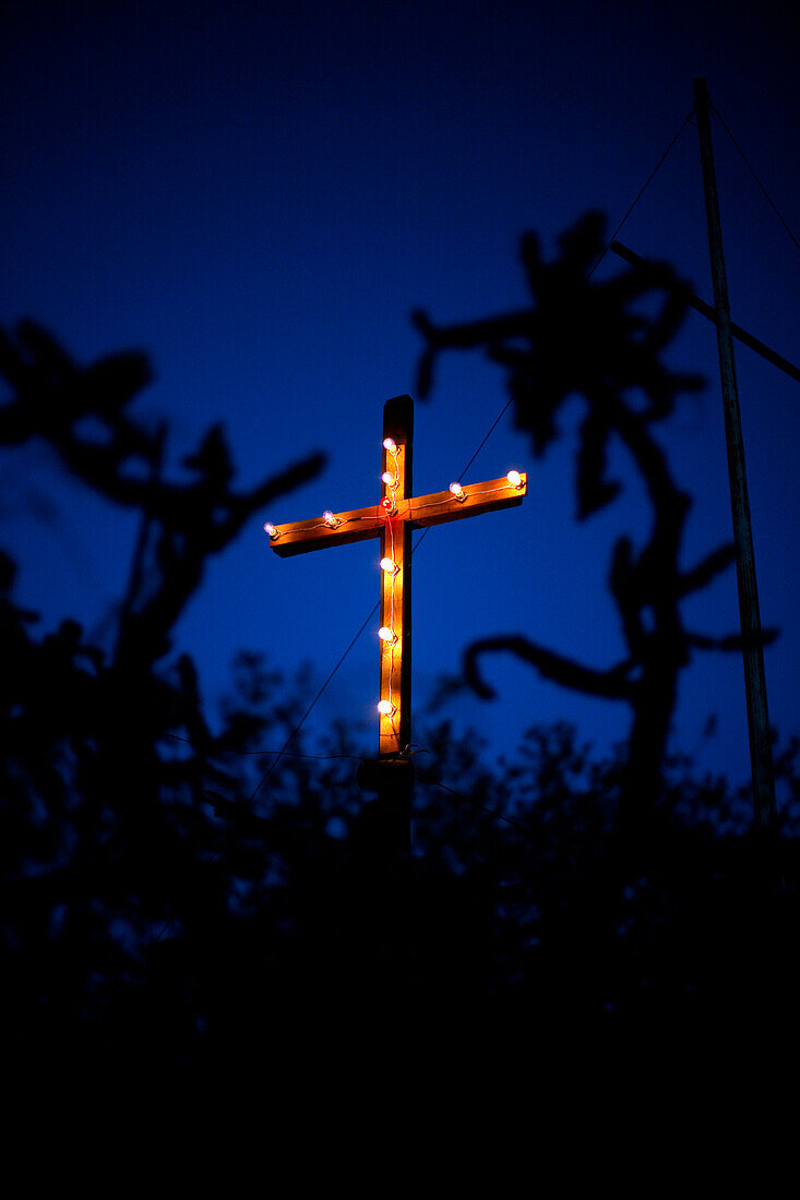 Illuminated crucifix outdoors at night
