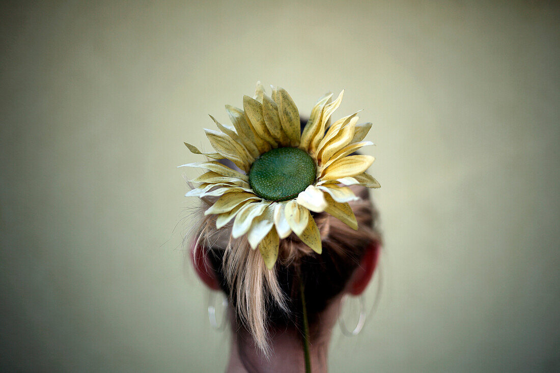 Sunflower in hair of Caucasian woman