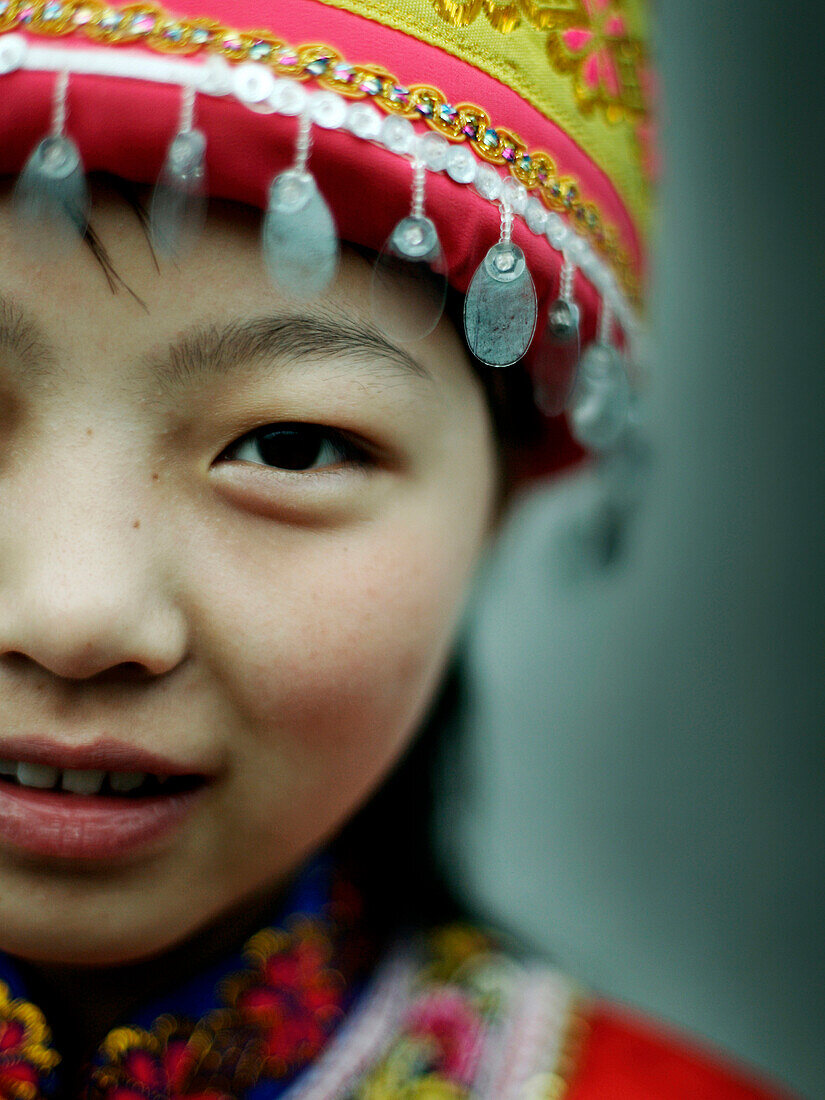 Close up of Asian girl wearing traditional hat