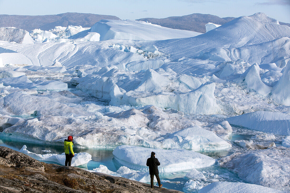 tourists in front of the spectacle that is the river of ice, jakobshavn glacier, 65 kilometres long, coming from the inlandsis, sermeq kujalleq, ilulissat, greenland