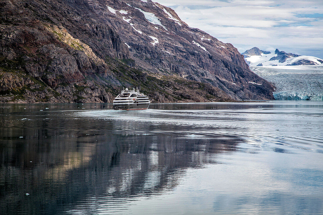 the boreal, cruise ship of the ponant line in front of a glacier, fjord in the prince christian sound, greenland