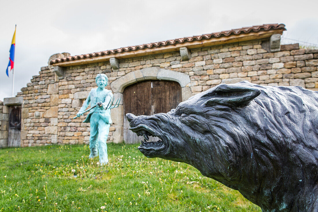 sculpture representing the man-eater of gevaudan menacing a young woman defended by portefaix, le malzieu (48), lozere, region of occitanie, france