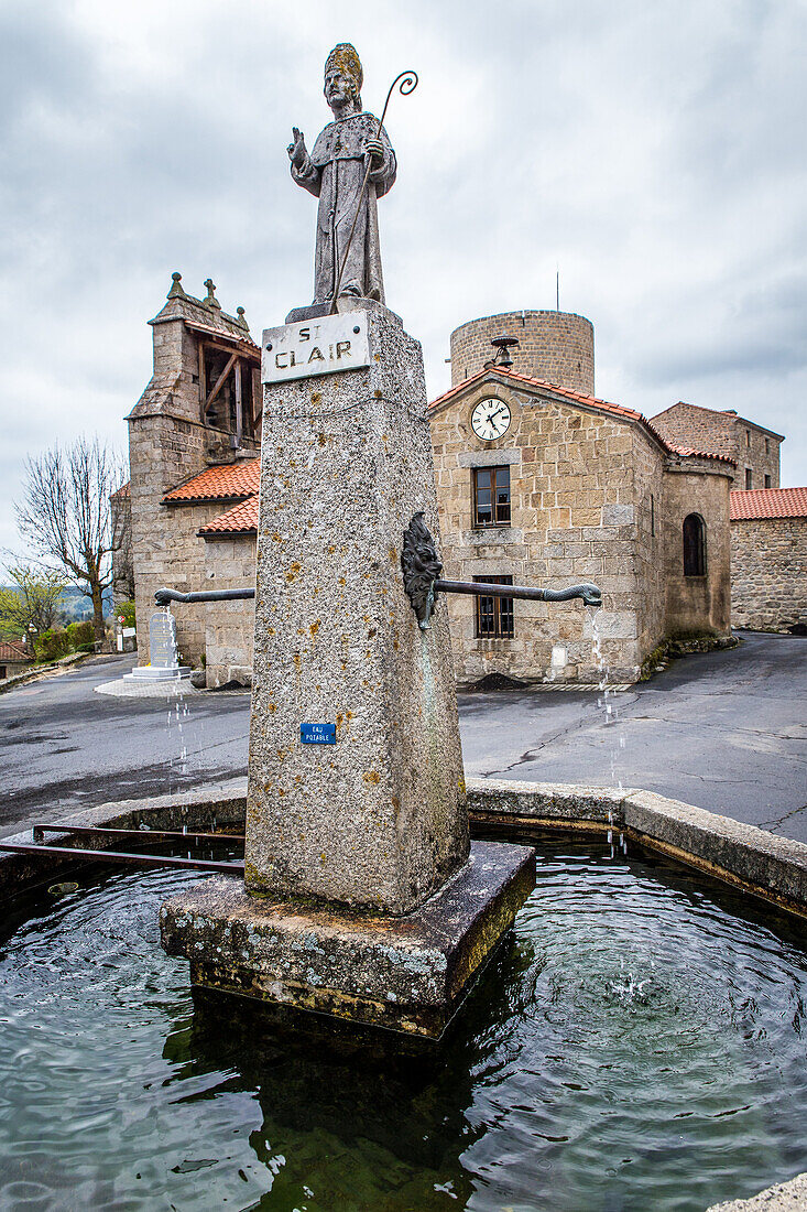 fountain ornamented with saint clair, belltower wall and keep, esplantas (43), haute loire, region auvergne rhone alpes, france