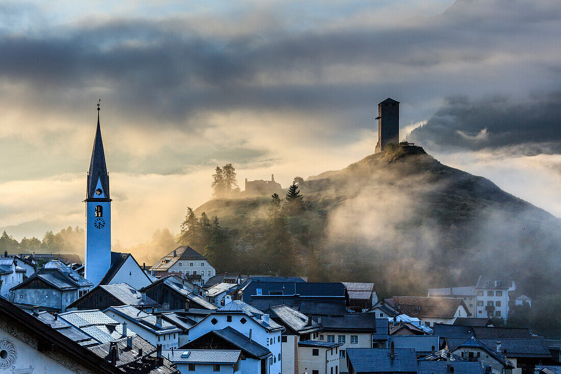 Misty sky on the alpine village of Ardez at sunrise, district of Inn, Lower Engadine, Canton of Graubunden, Switzerland, Europe