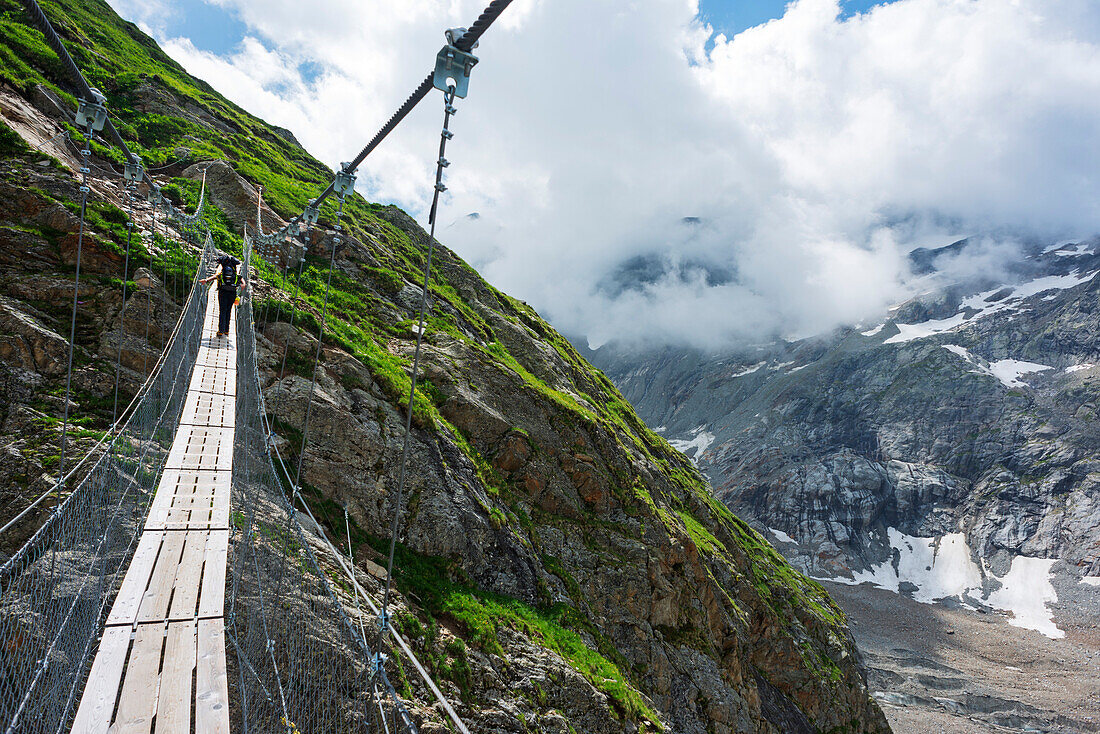 Hiker on a suspension bridge, Chamonix, Rhone Alpes, Haute Savoie, France, Europe