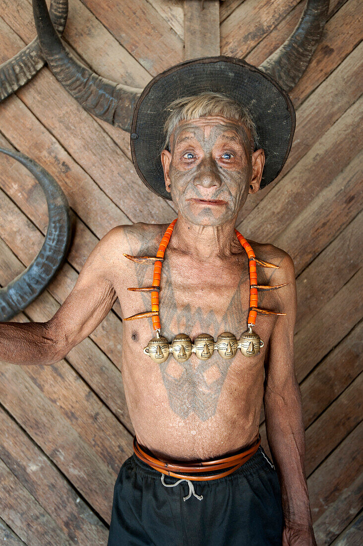 Wangchah Wangsa, Naga headhunter, with tattooed face and tribal necklace, and chest tattoo marking him as having taken heads, Nagaland, India, Asia