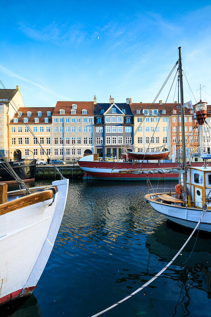 Boats in Christianshavn Canal with typical colourful houses in the background, Copenhagen, Denmark, Europe
