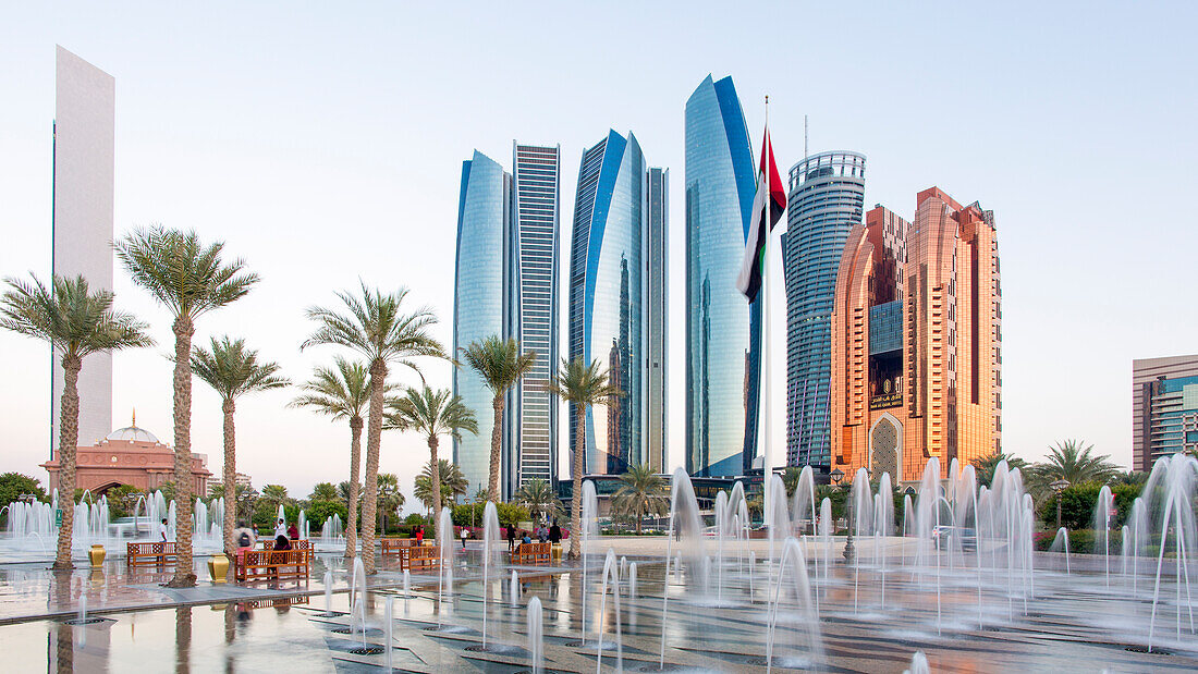 Etihad Towers viewed over the fountains of the Emirates Palace Hotel, Abu Dhabi, United Arab Emirates, Middle East