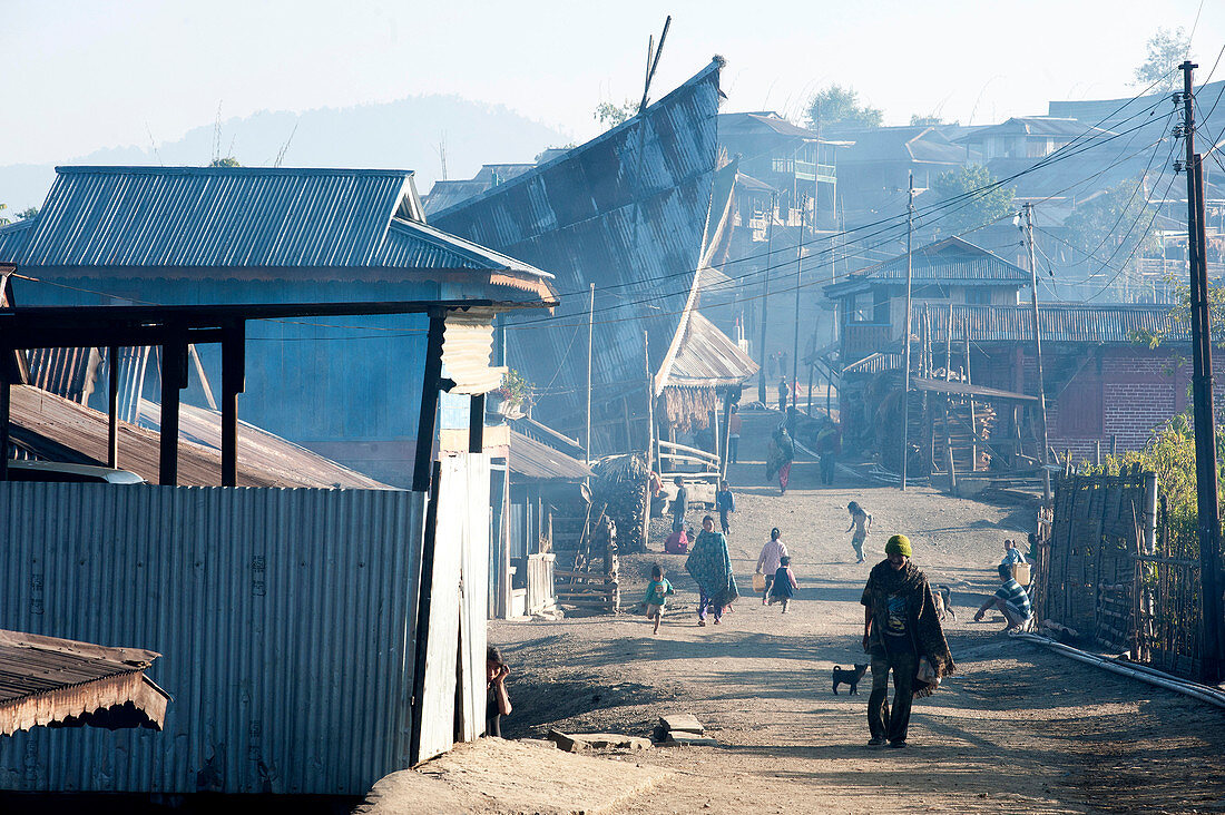 Naga villagers in the early morning, going about their business in Chanlangshu Naga village, Nagaland, India, Asia