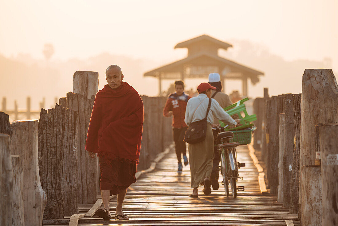 Early morning pedestrian traffic on U-Bein Bridge, Amarapura, Mandalay, Mandalay Region, Myanmar (Burma), Asia