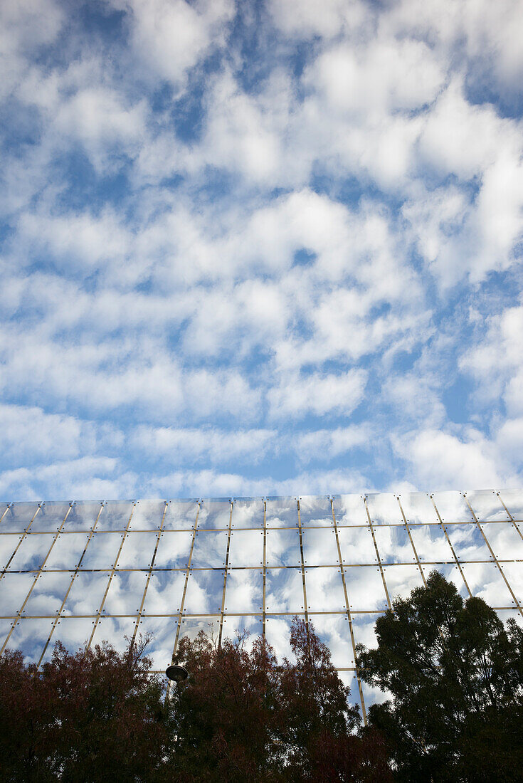 France, South-Western France, Bordeaux, building facade made entirely of glass, reflection of clouds