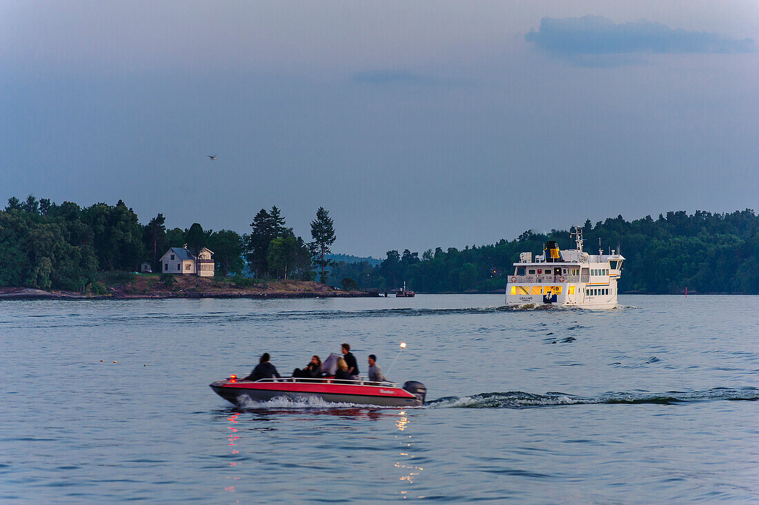 Young people in motorboat in Vaxholm, Stockholm, Sweden