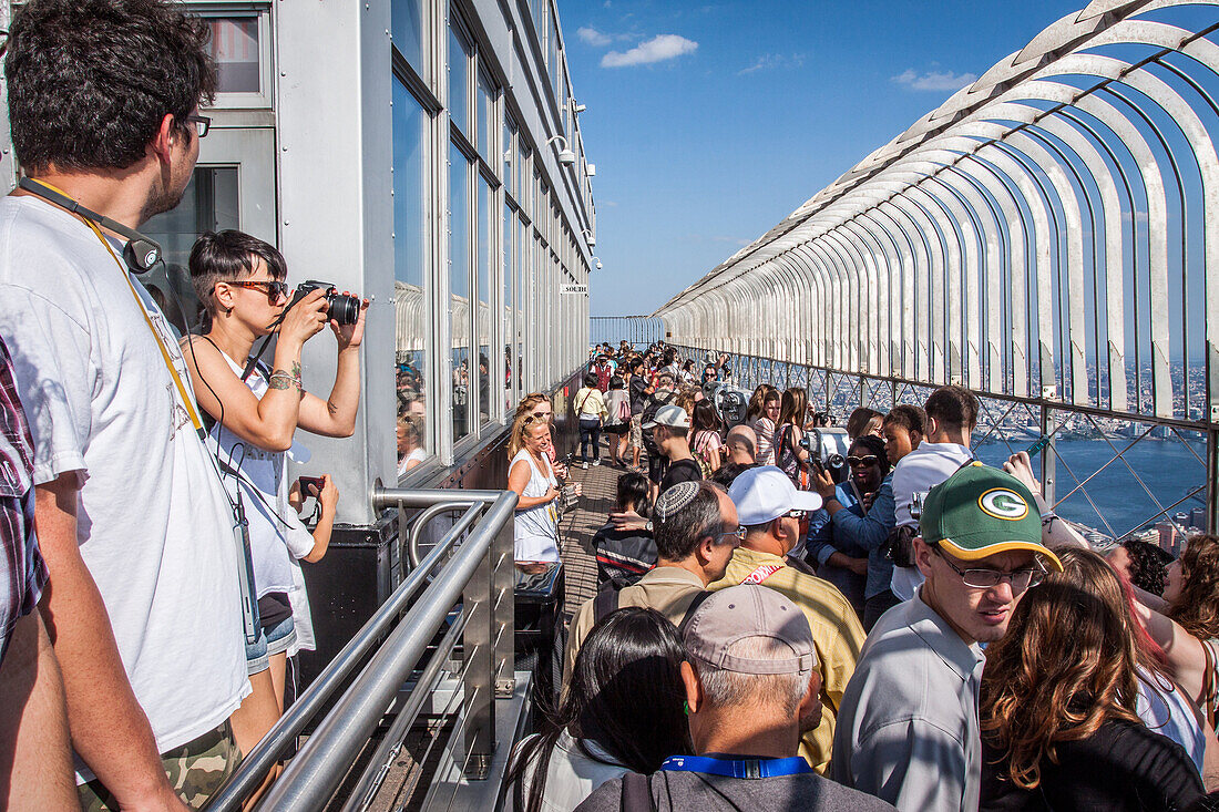 tourists contemplating the view of new york from the observatory of the empire state building, midtown, manhattan, new york city, state of new york, united states, usa