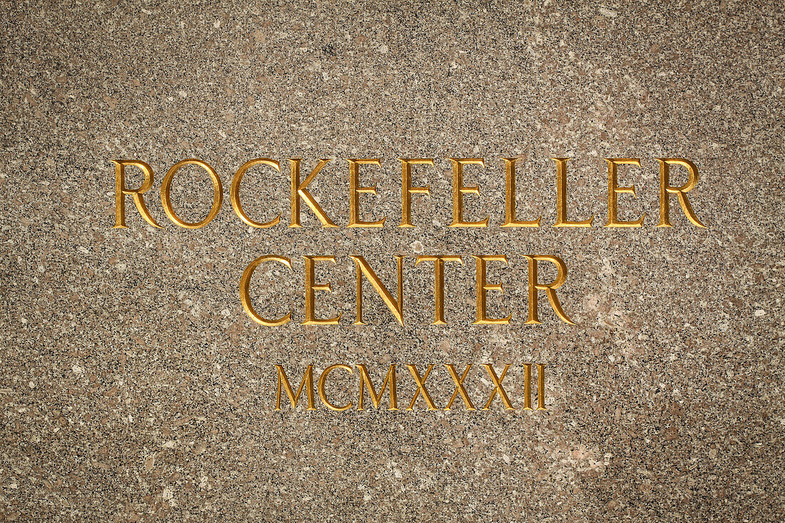 plaque engraved in the marble marking the entrance to rockefeller center, midtown, manhattan, new york city, state of new york, united states, usa