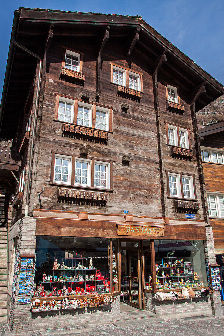 chalet with a souvenir shop on the ground floor in the town centre of zermatt, ski resort, zermatt, canton of valais, switzerland