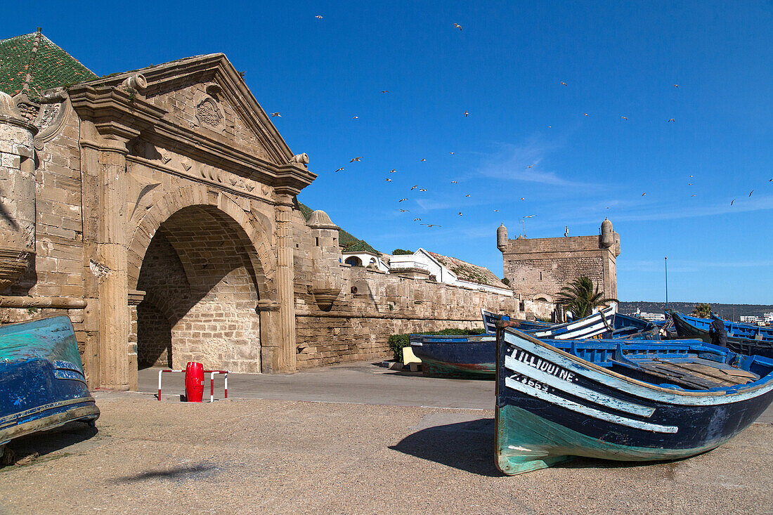 traditional boats at the skala of the port in front of the porte de la marine, essaouira, mogador, atlantic ocean, morocco, africa