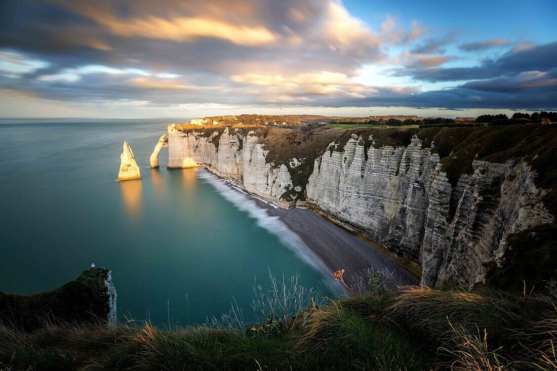 long exposure shot of the needle and the cliffs of etretat and the porte d'aval at sunset, seine-maritime (76), upper-normandy, france