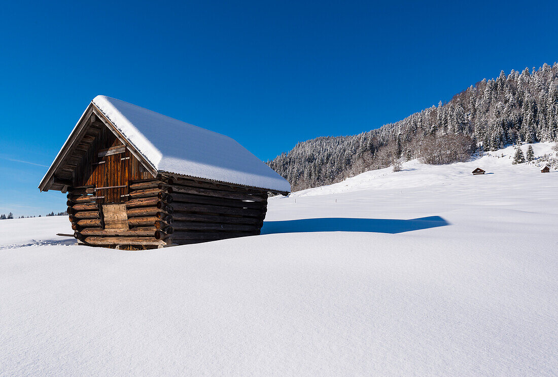 beautiful winter weather and fresh snow and on a barn near Wagenbrüchsee, Bavaria, Germany