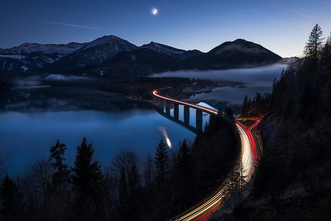 lighttrails of cars crossing the Faller-Klamm-bridge at the Sylvensteinspeicher, Lenggries, Bavaria, Germany