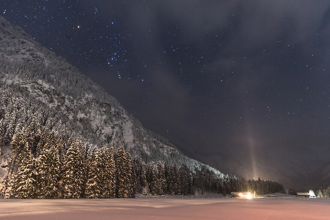 Germany, Bavaria, Oberallgaeu, Oberstdorf, Stillachtal, Alps, winter landscape at night, starry sky, winter holidays, mountain farm at night in snow, snowfall, mountains, coniferous forest, pines