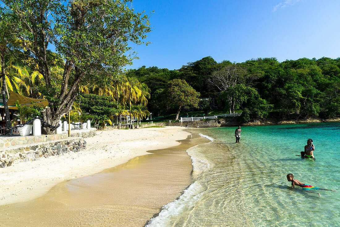 Persons swimming, Admiralty's beach bay, Bequia, Saint-Vincent and the Grenadines, West Indies.