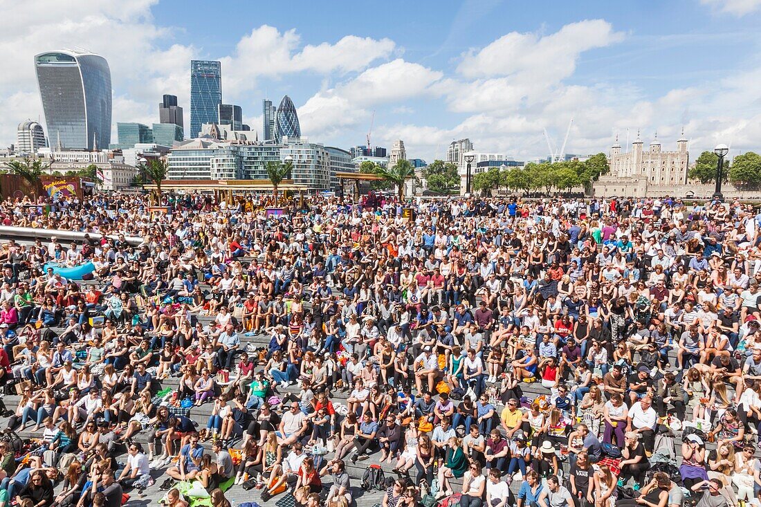 England, London, Southwark, Crowds at the Scoop Open Air Theatre and City of London Skyline