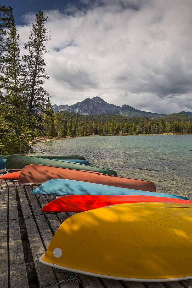 Colourful canoes and kayaks on the bank of Annette Lake with Pyramid Mountain in the background, Jasper National Park, UNESCO World Heritage Site, Canadian Rockies, Alberta, Canada, North America
